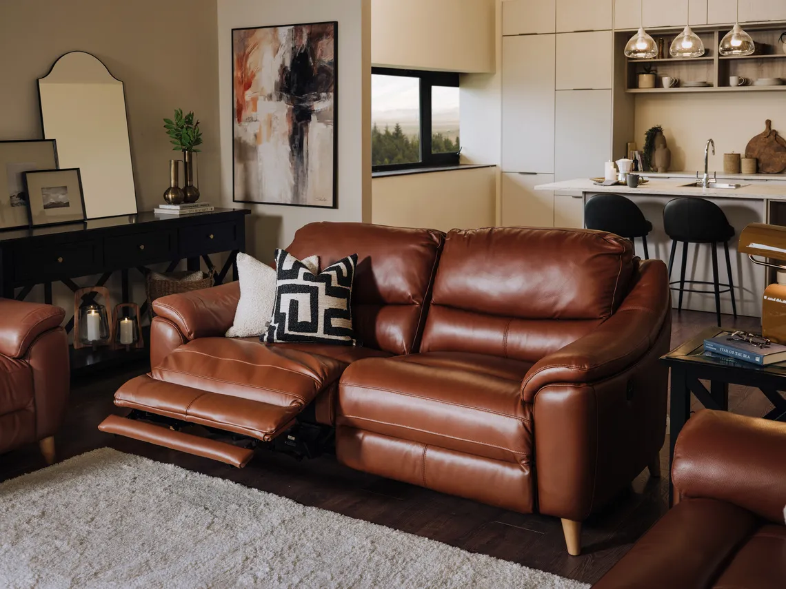 A lifestyle image of the Blaze 2 seater reclined sofa with Hampton black tables.