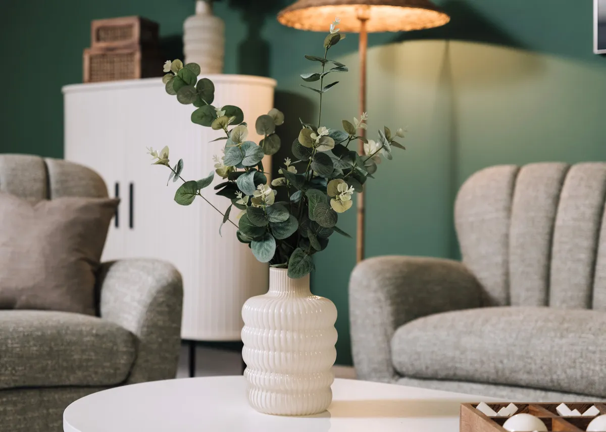 A lifestyle image of the Lunette vase with Amber silver sofas.