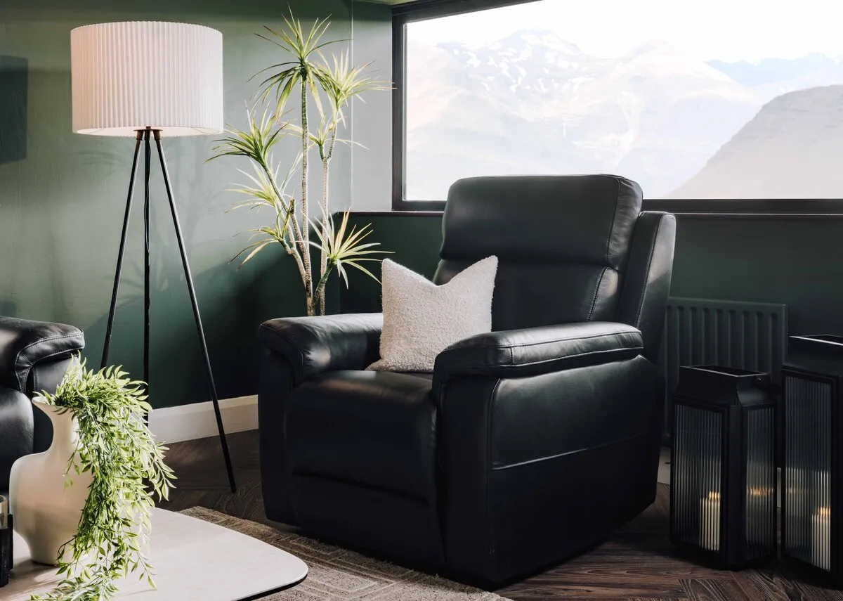 A lifestyle image of the Raven recliner in fixed mode with Starlette lamp and lanterns