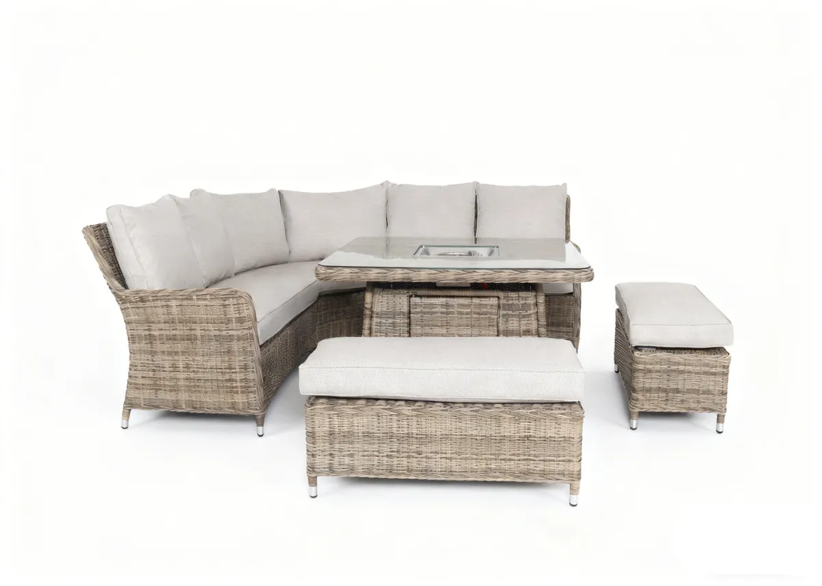 A beige corner garden sofa with 2 ottomans and a glass top rising table. Front view of table with rectangular shaped ottomans