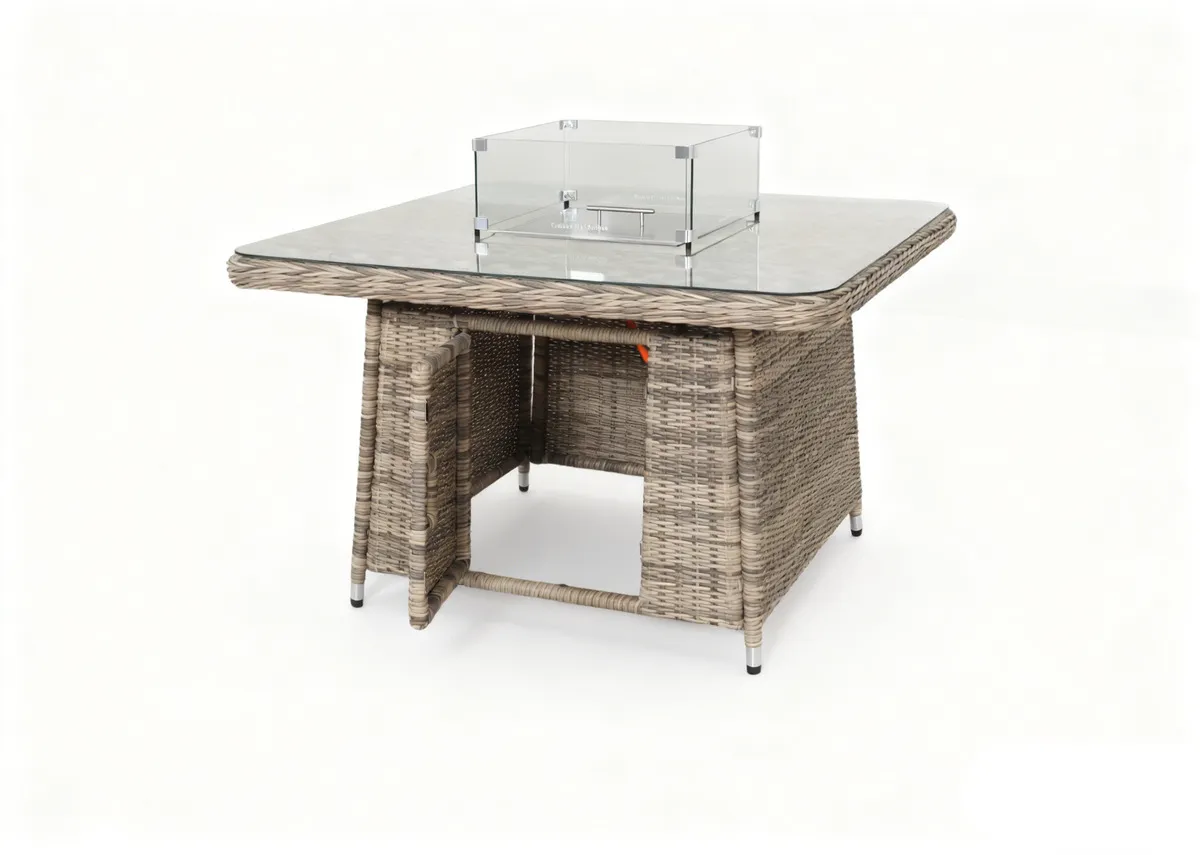 A beige corner garden sofa with 2 ottomans and a glass top rising table. Table showing door for gas canister underneath