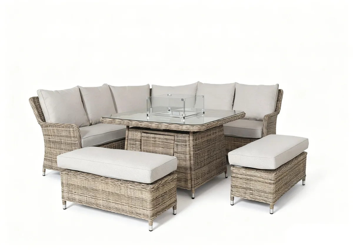 A beige corner garden sofa with 2 ottomans and a glass top rising table. Angled view of full set with removable cushions.