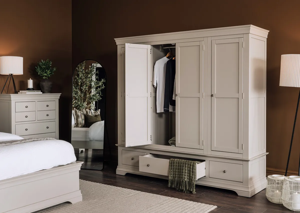 A lifetsyle image of the Dove taupe wardrobe with a door open showing the interior storage 