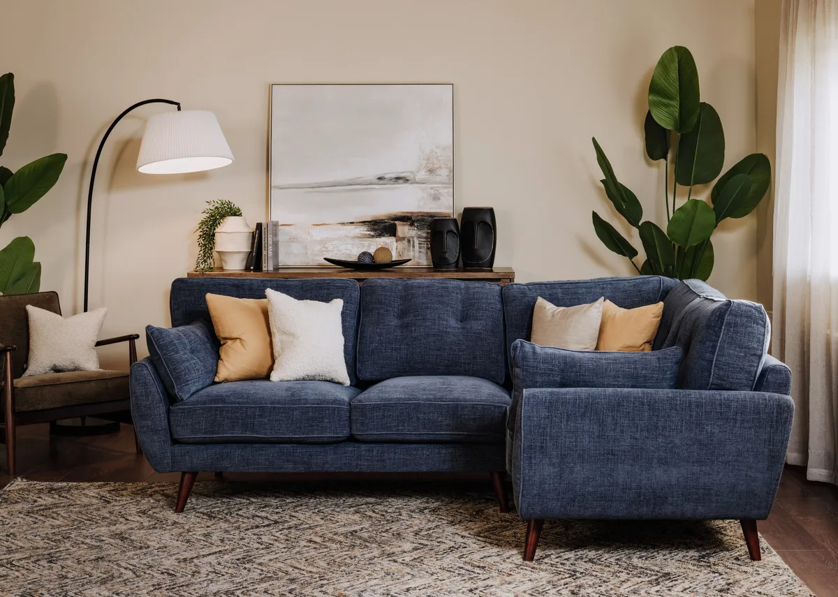 A lifestyle image of the Caoimhe Corner sofa with the Arc floor light with Savanna