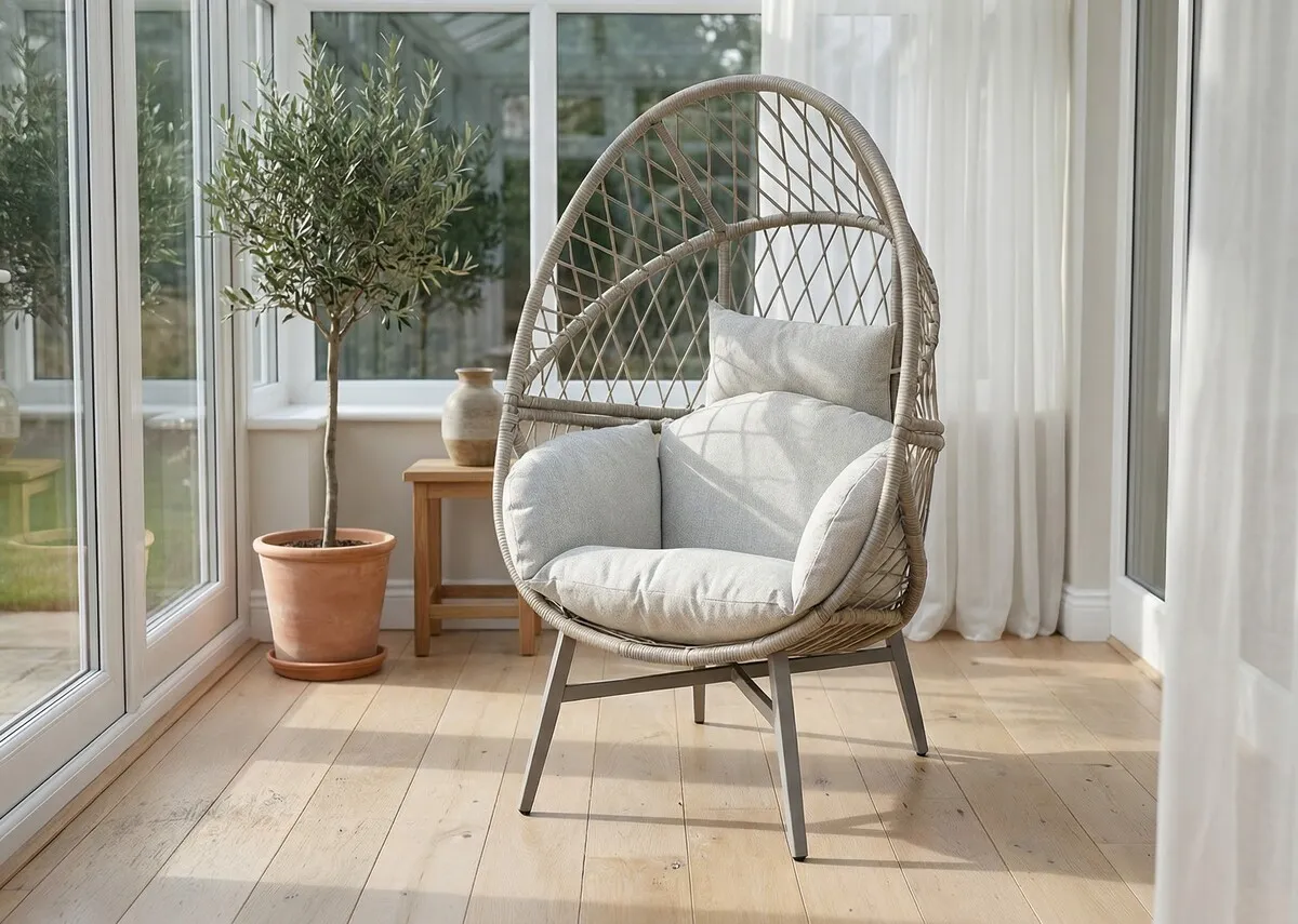 A lifetsyle image of the Maya egg chair in a conservatory space with a wood panel floor.