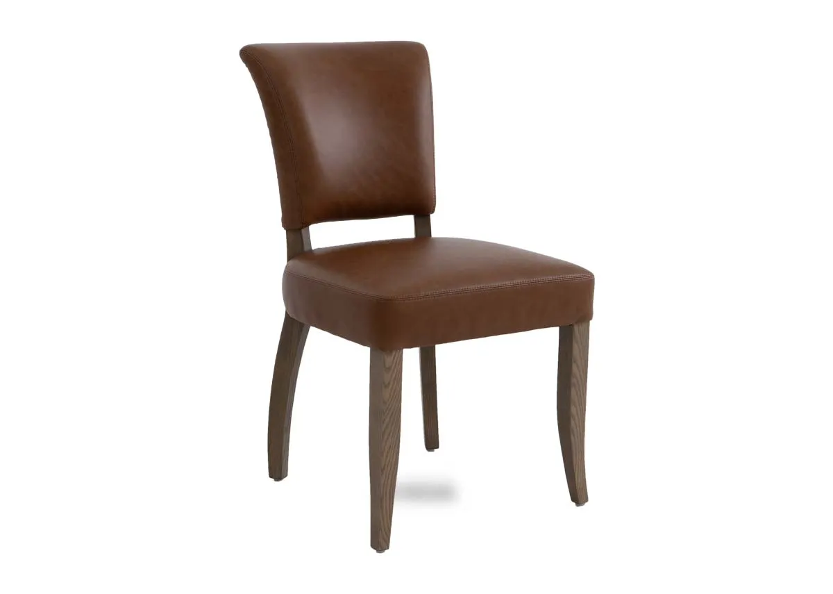 A tan leather dining chair from EZ Livings Geneva range. Angled view of genuine brown leather seat and back.