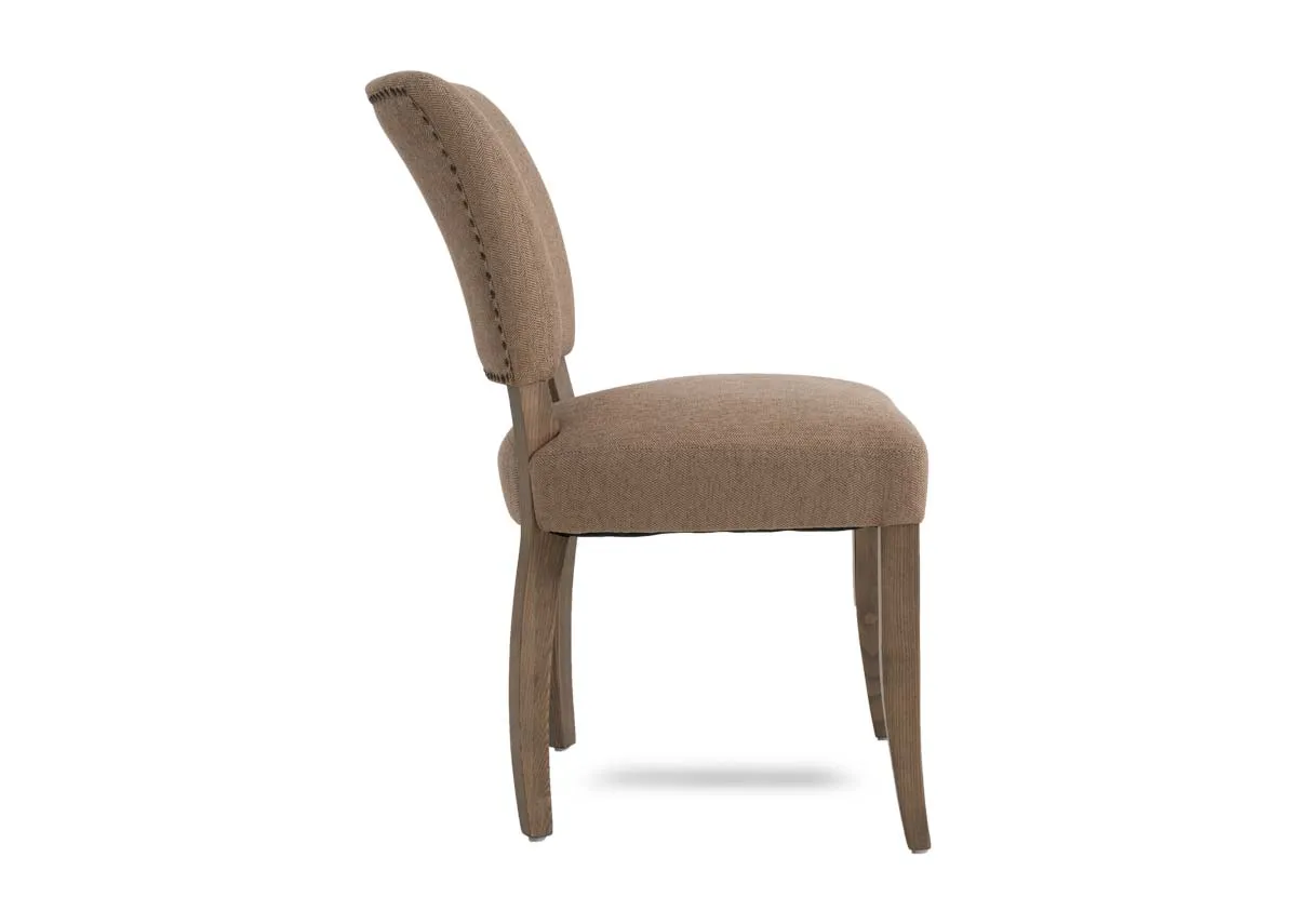 A beige fabric dining chair from EZ Livings Geneva range. Side view