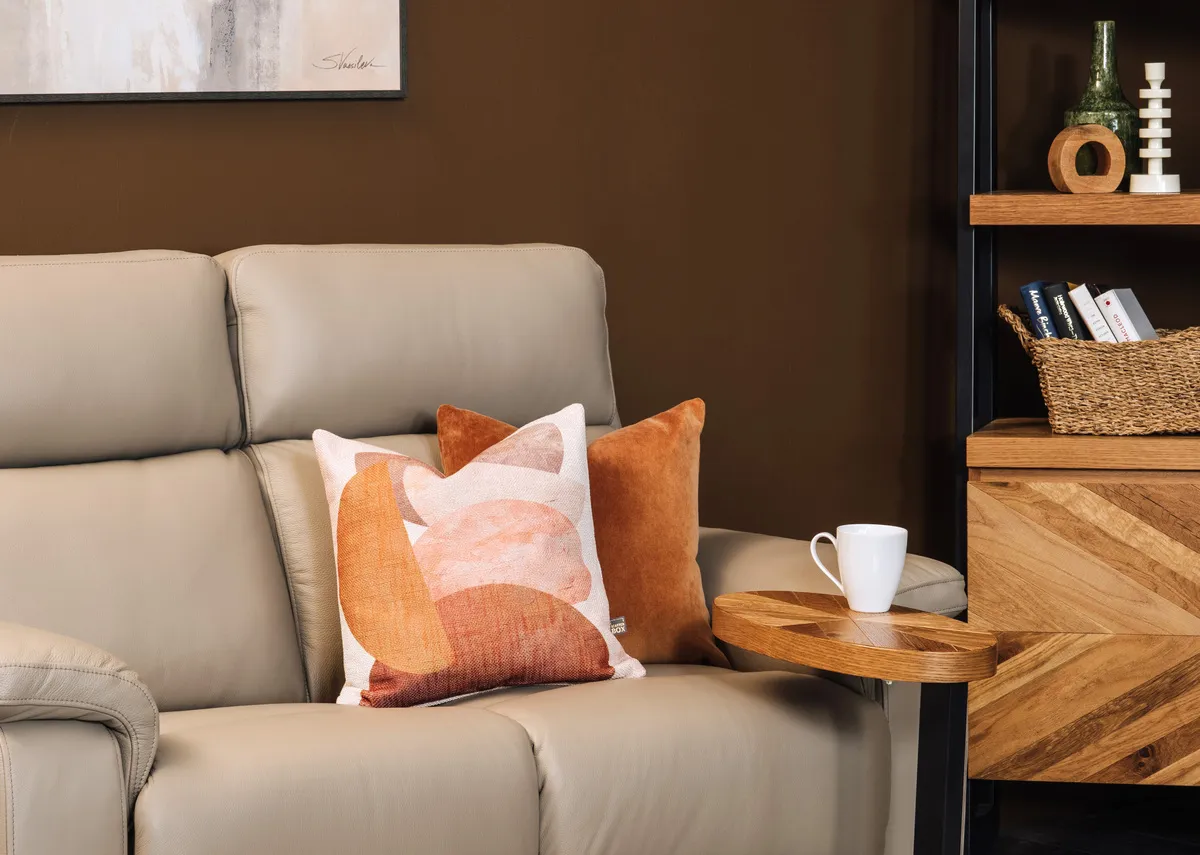 A geo stack clay cushion on the Raven oyster leather sofa with Ellipse sofa table.