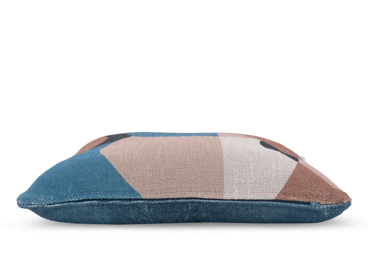 A blue geo print cushion with terracotta and pink shapes Side view shows feather filled padding.
