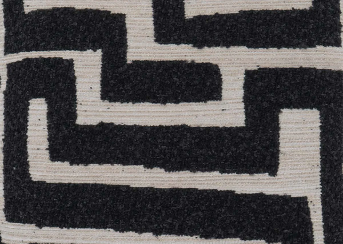 A cream cushion with dark grey maze like design from EZ Livings Zephyr range.Closeup of design.