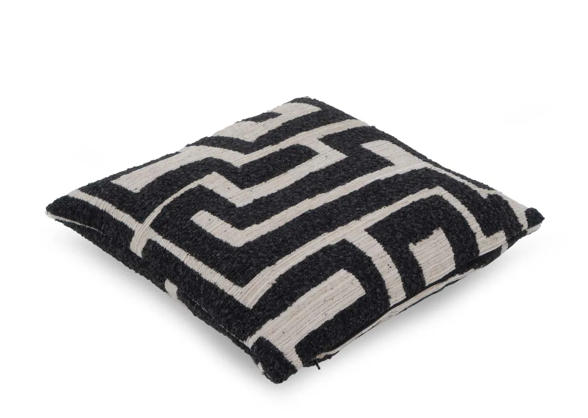 A cream cushion with dark grey maze like design from EZ Livings Zephyr range.Angled view