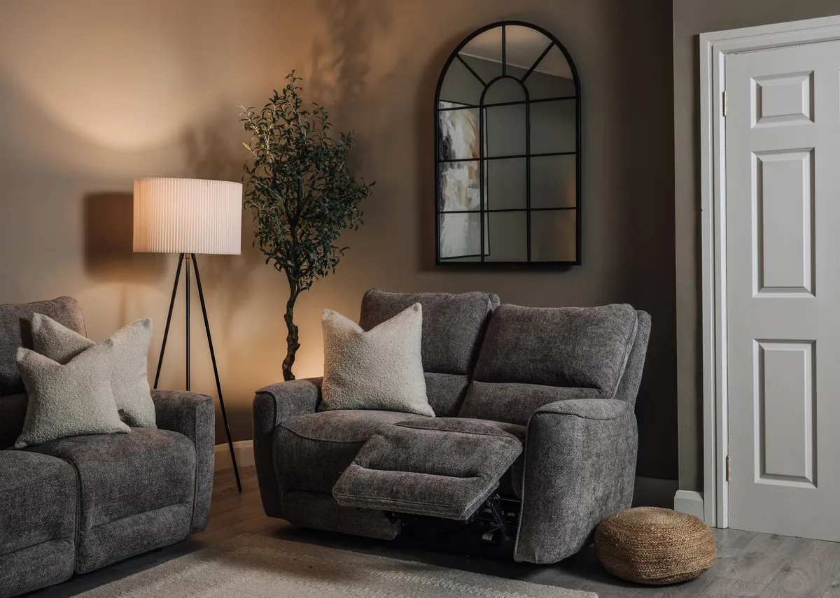 A lifestyle image of the Ashbrook 2 seater sofa with the Bella mirror and Starlette lamp.