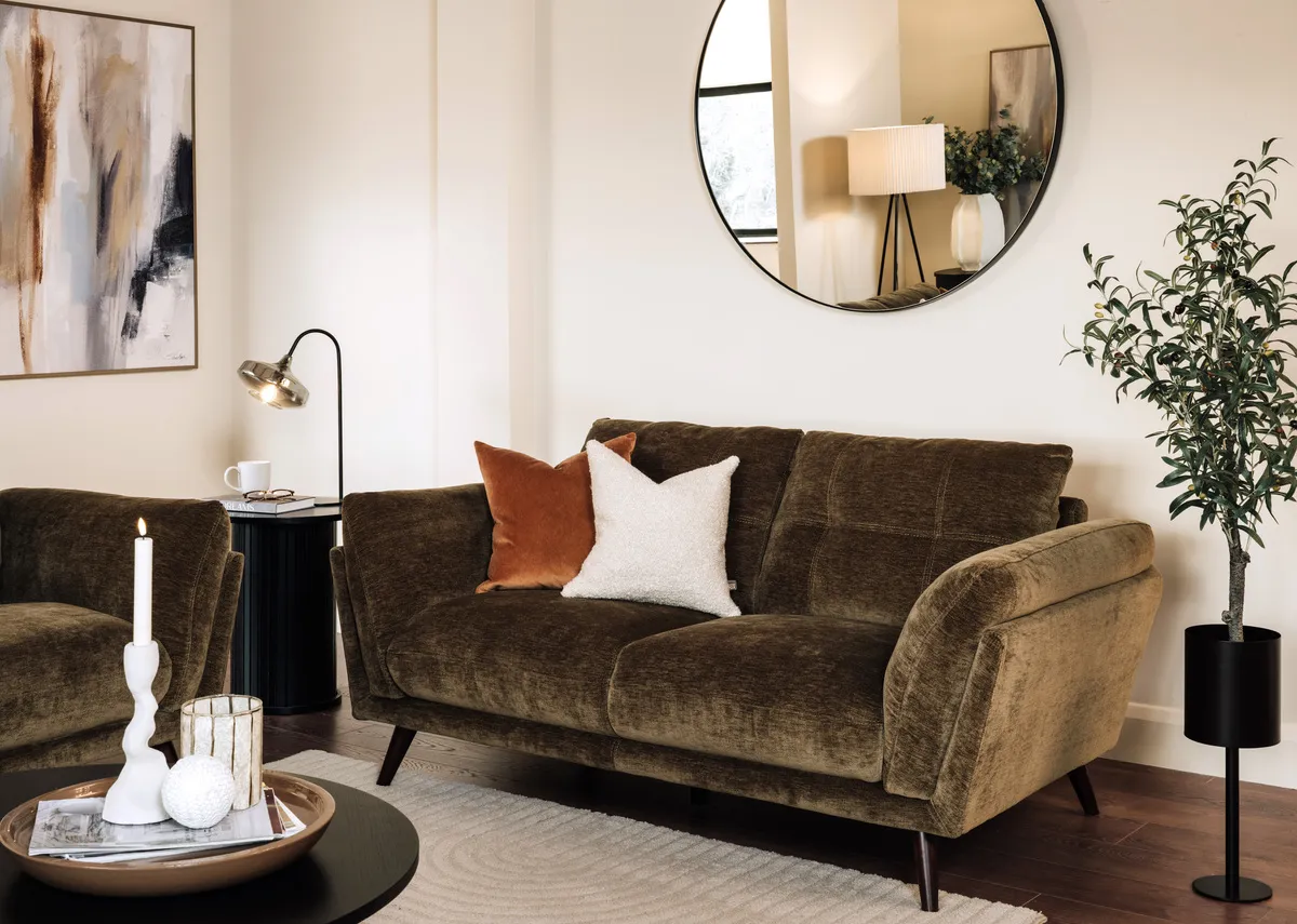 A lifestyle image of the Toscana 2 seater sofa with elling mirror and Inspired canvas.