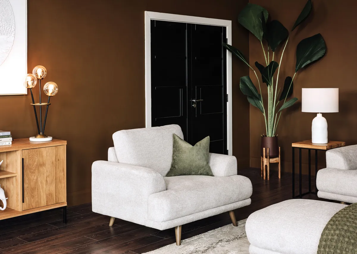 A lifestyle image of the Legend stone armchair with Renvyle sideboard