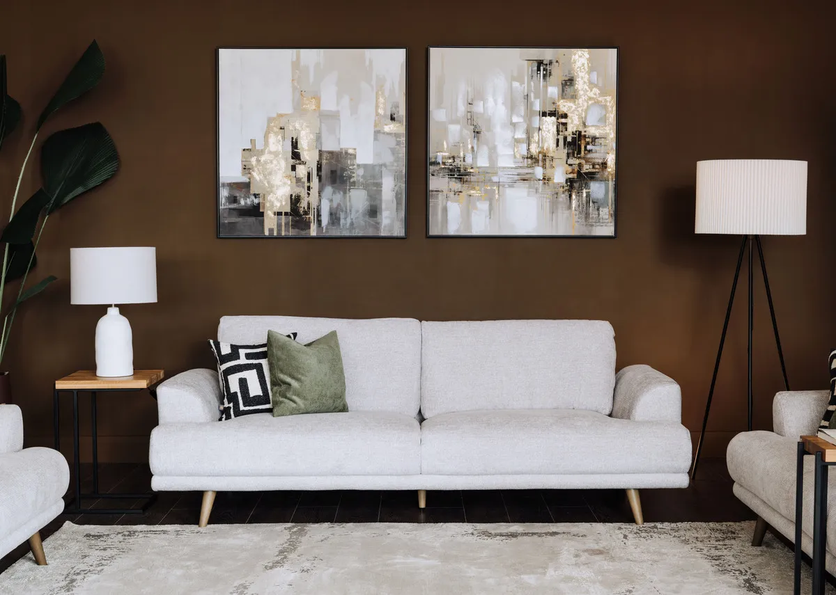 A lifestyle image of the Legend 3 seater sofa with the Lifted canvas 1 and 2