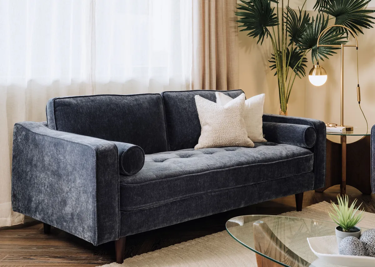 A lifetsyle image of the Genoa sofa with casper lamp and glass top table