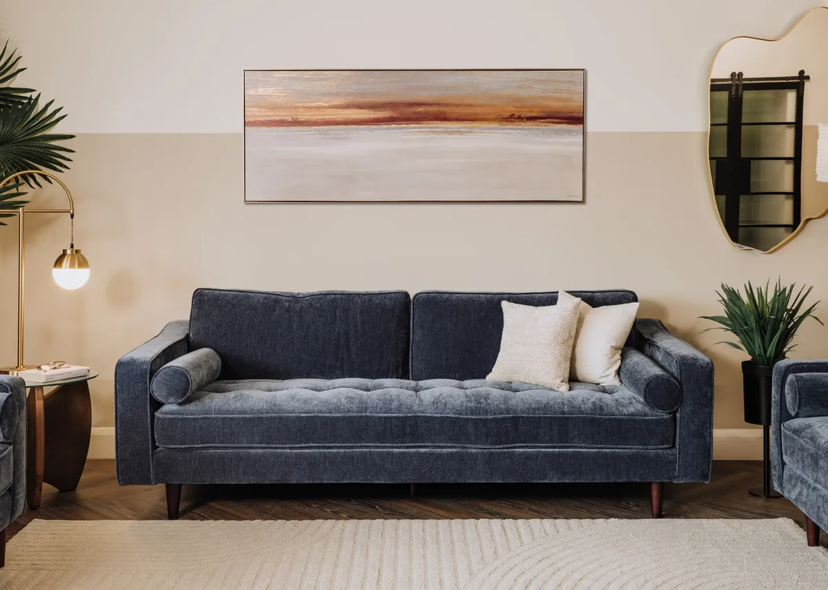 A lifetsyle image of the Genoa sofa with Benton mirror and Evening peace canvas