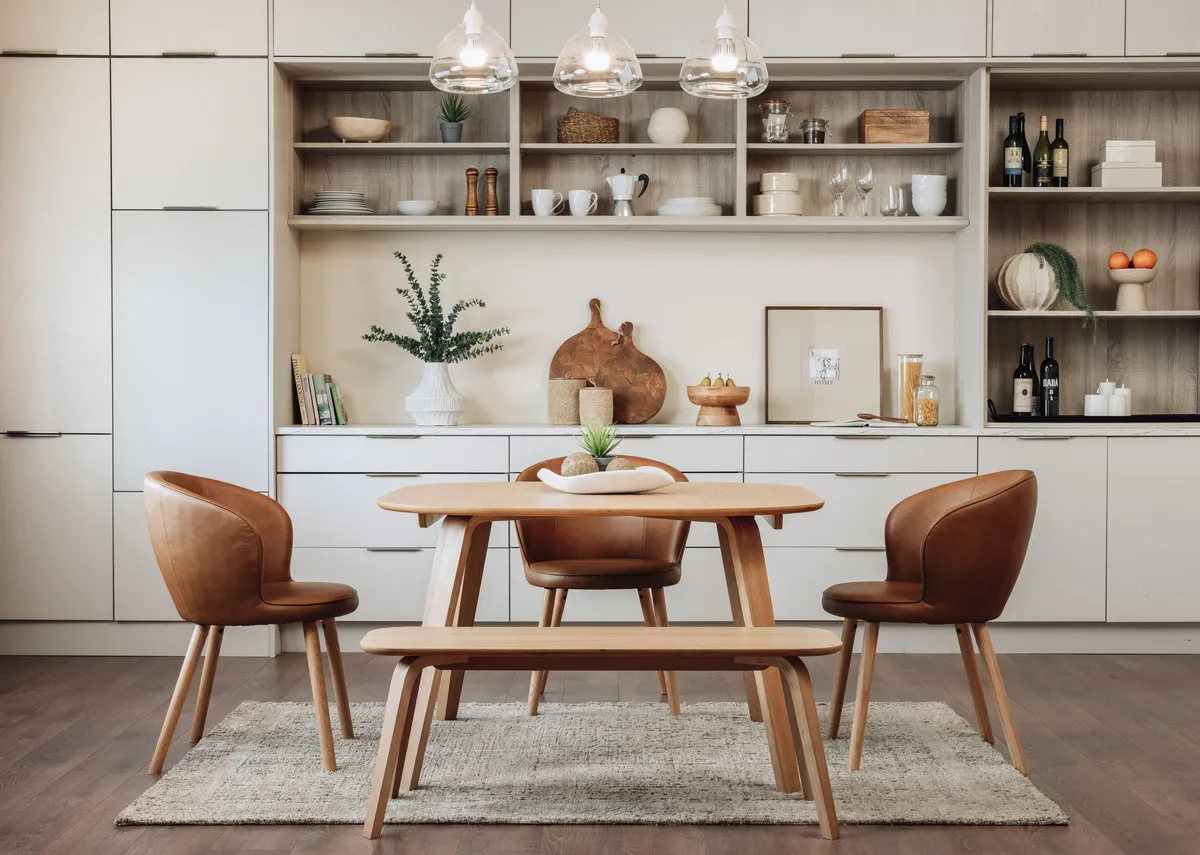 A lifestyle image of the Anton dining table with Gain chairs in brown and matching bench.