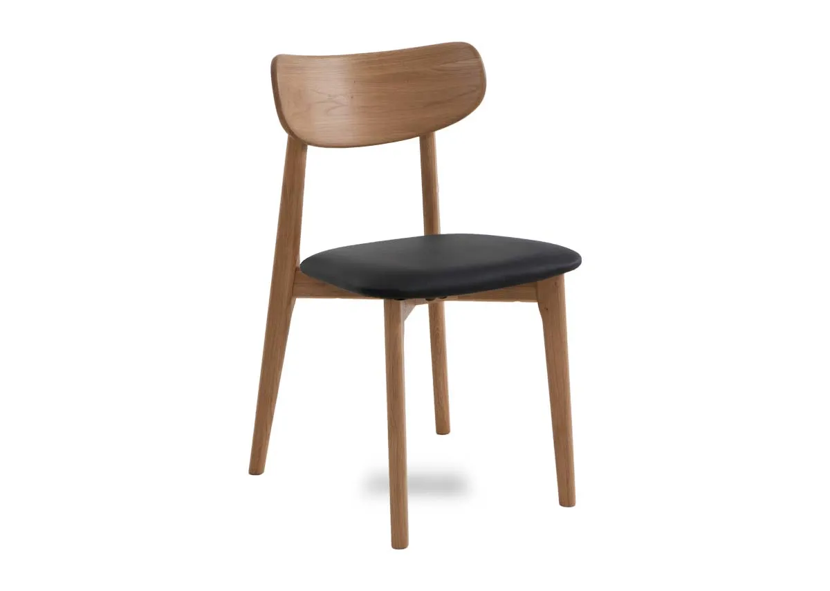 An oak dining chair with a black faux leather seat from EZ Livings Bari range. Angled view