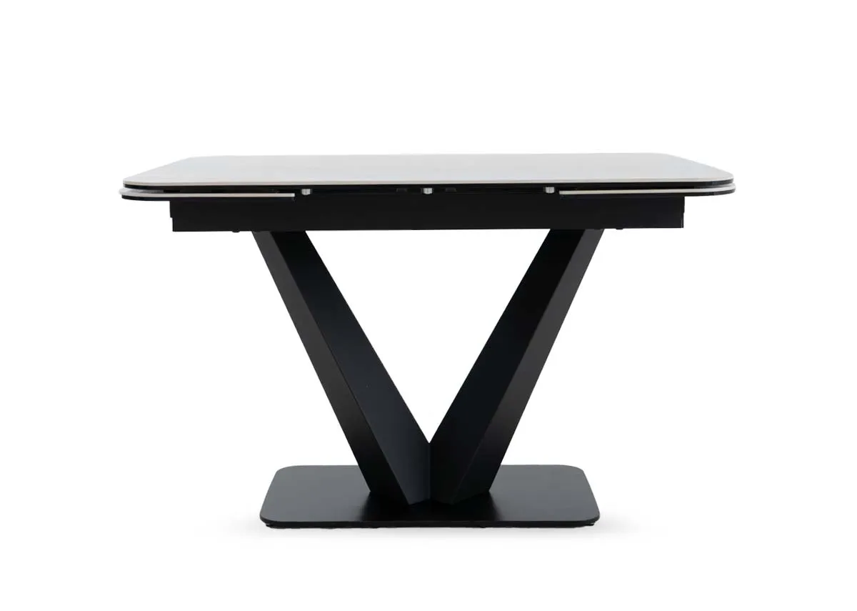 An off white ceramic top dining table from EZ Livings Tuscan range.Side view of the table not extended