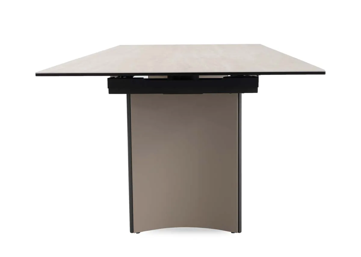 A beige ceramic table with revolving extension from EZ Livings Turin range.Closeup of travertine table finish