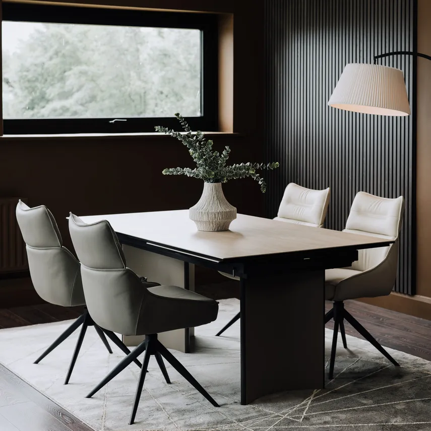 A lifestyle image of the Turin dining table with matching turin chairs on Avery rug with arc lamp.