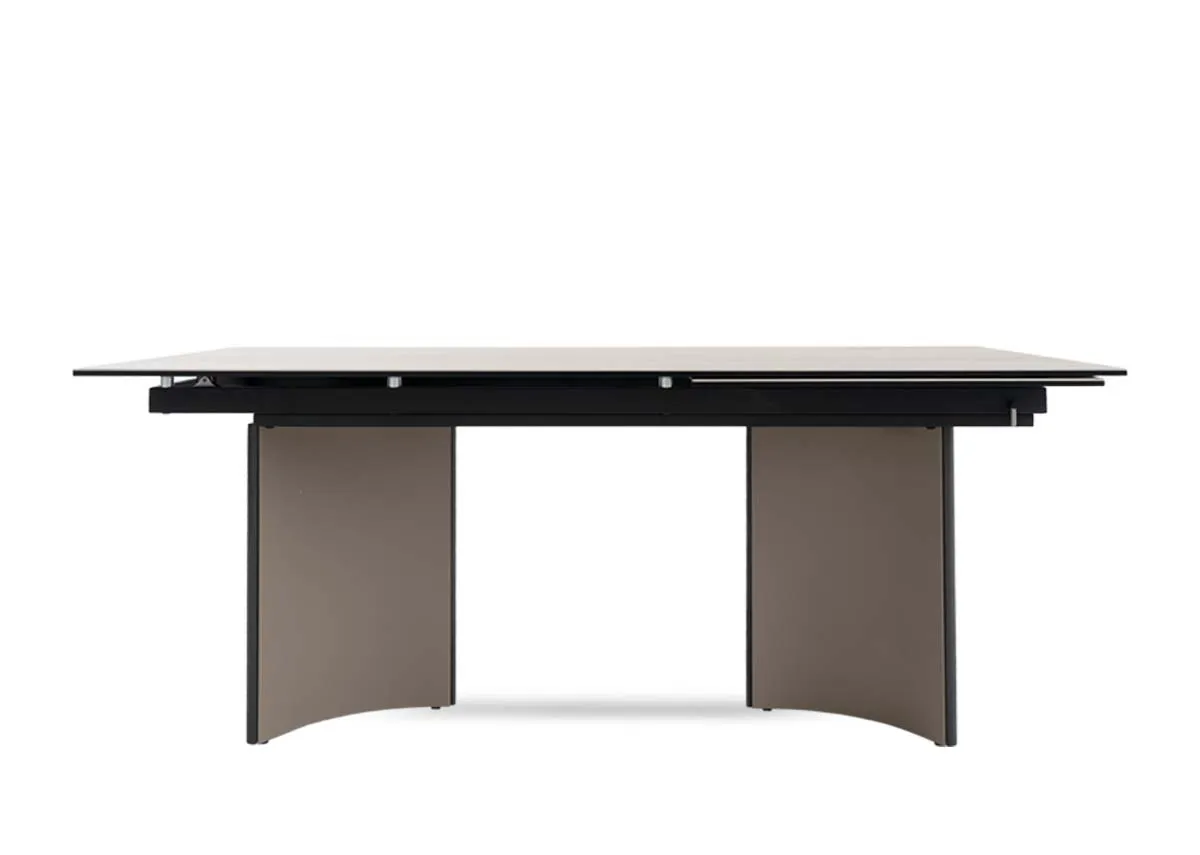 A beige ceramic table with revolving extension from EZ Livings Turin range.Side  veiw of arced legs