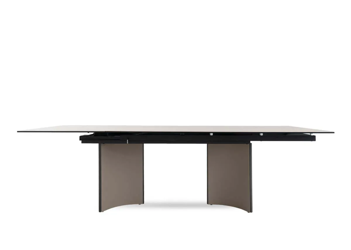 A beige ceramic table with revolving extension from EZ Livings Turin range.Front view of table fixed