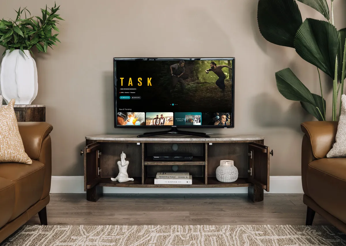 A lifestyle image of the Eden tv unit with doors opn showing ornments.