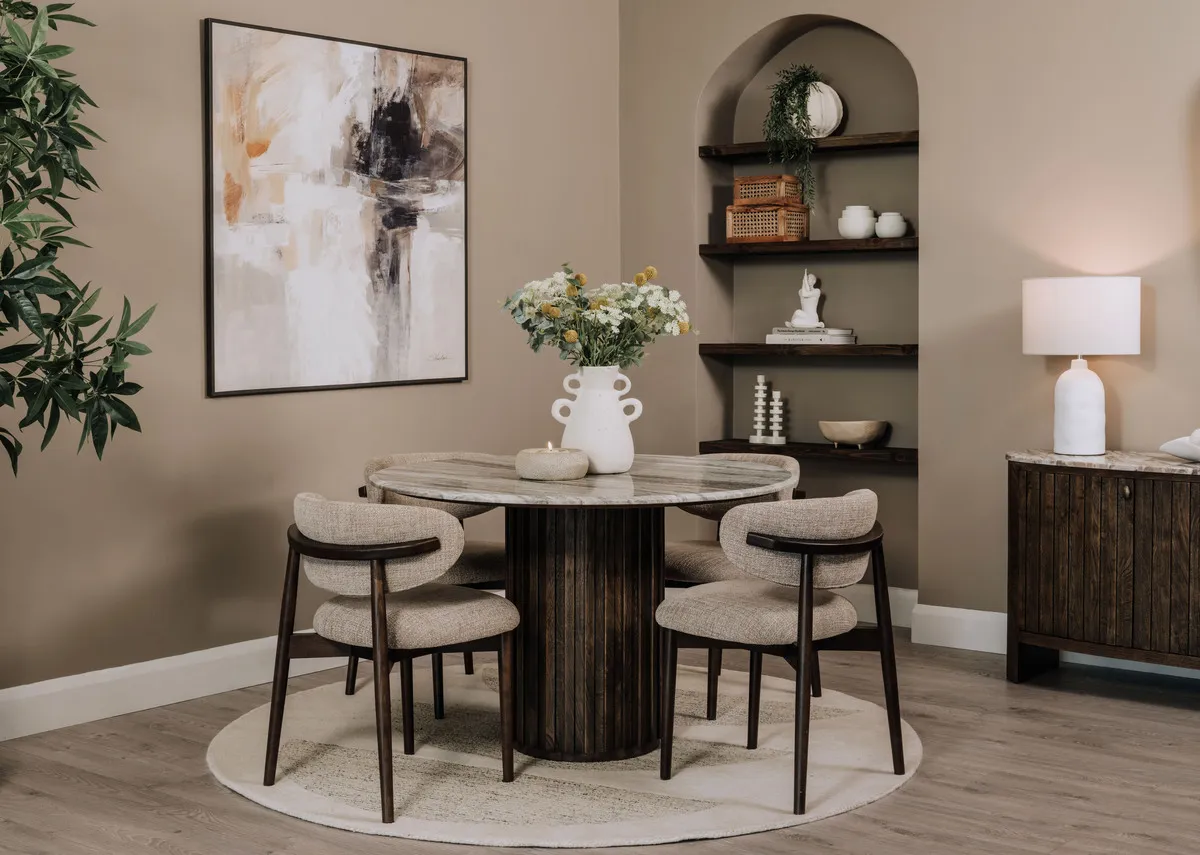 A lifestyle image of the Eden round dining table with Hazel chairs and Eden sideboard.