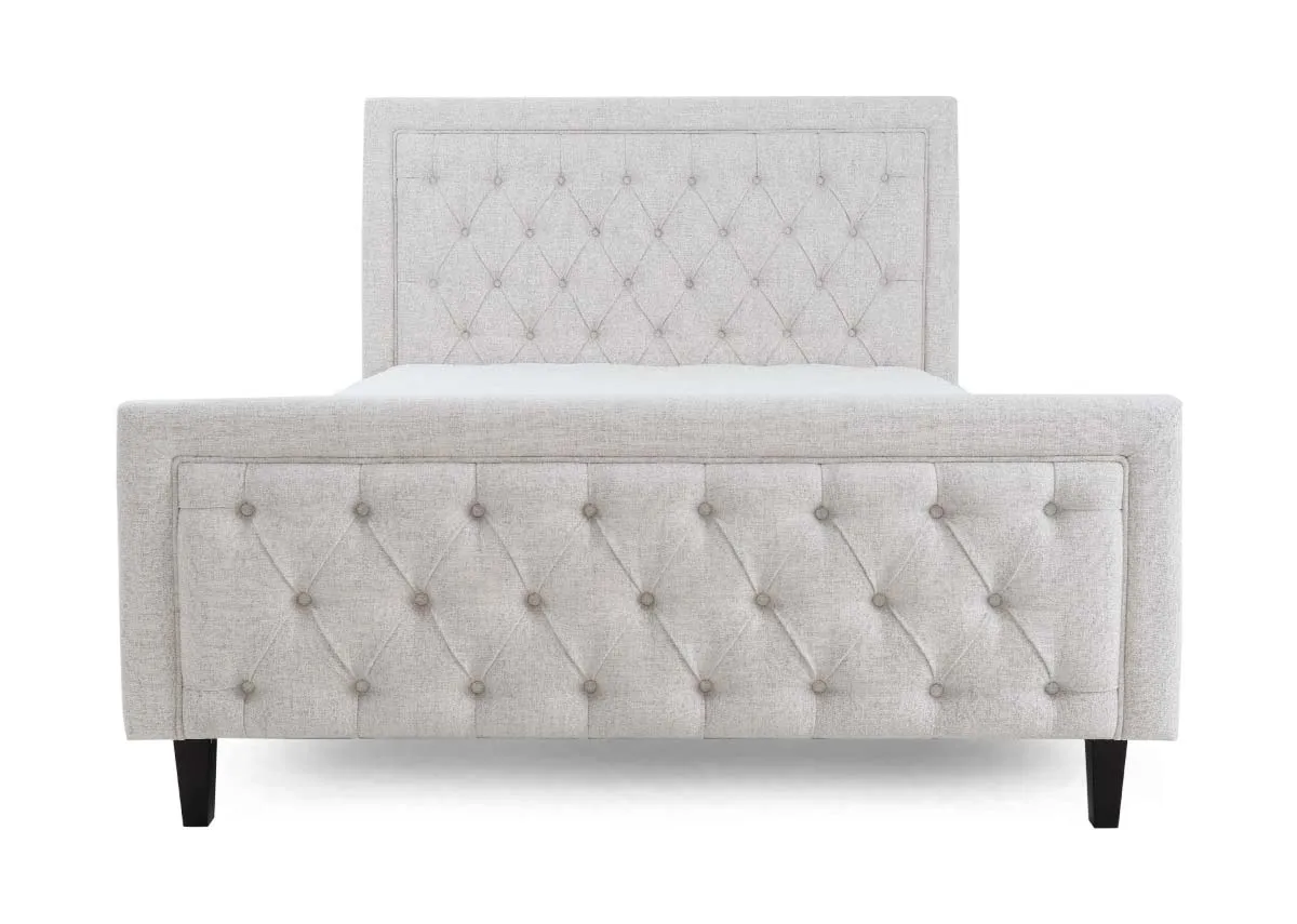 A 4ft6 double bedframe with high tufted head and footboard from EZ Livings Majestic range. Front view of panel detail at foot.