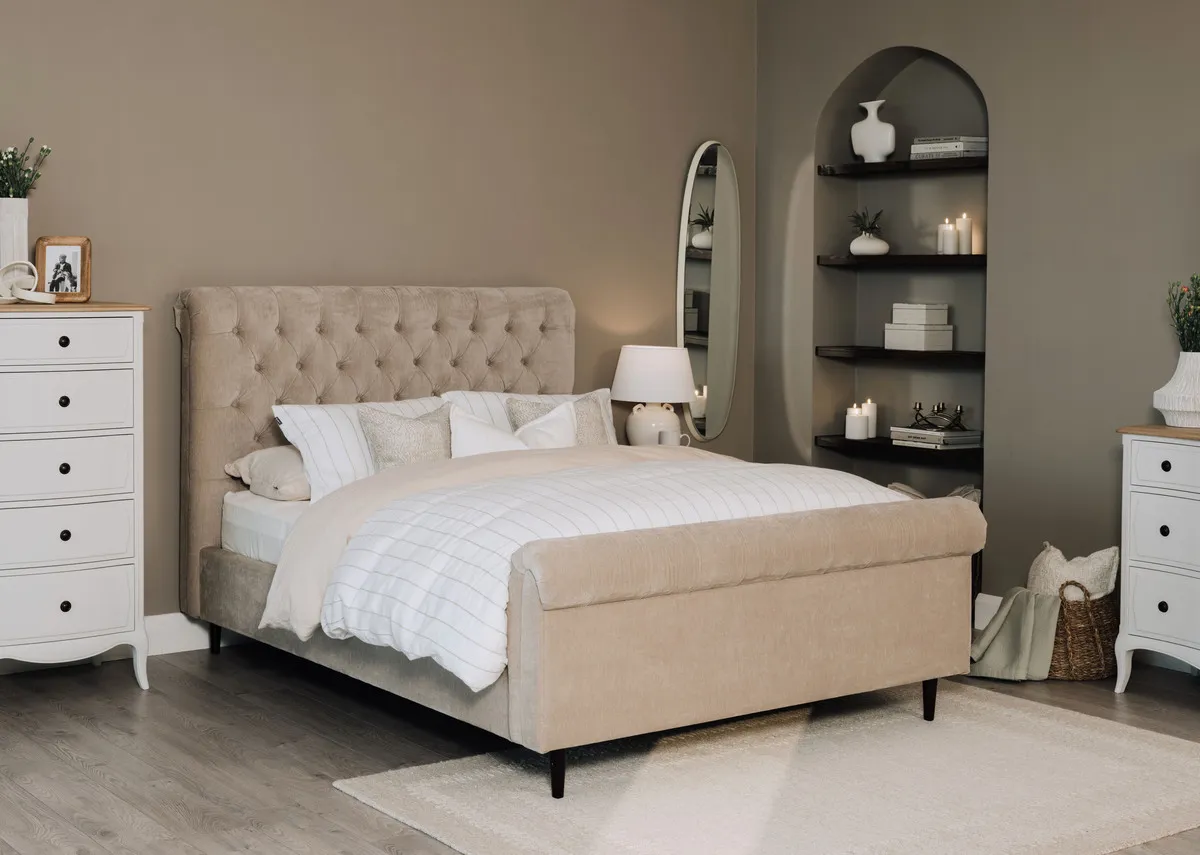 A lifetsyle image of the Sofia taupe bedframe with Amelie chests and Lana mirror.