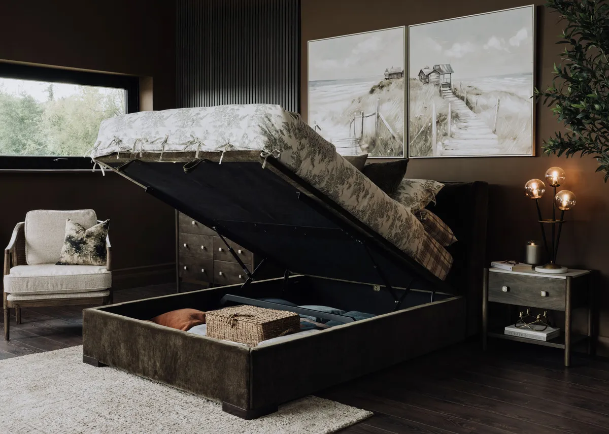 A lifestyle image of the Comfy ottoman open open with nora locker and Eve toile duvet set