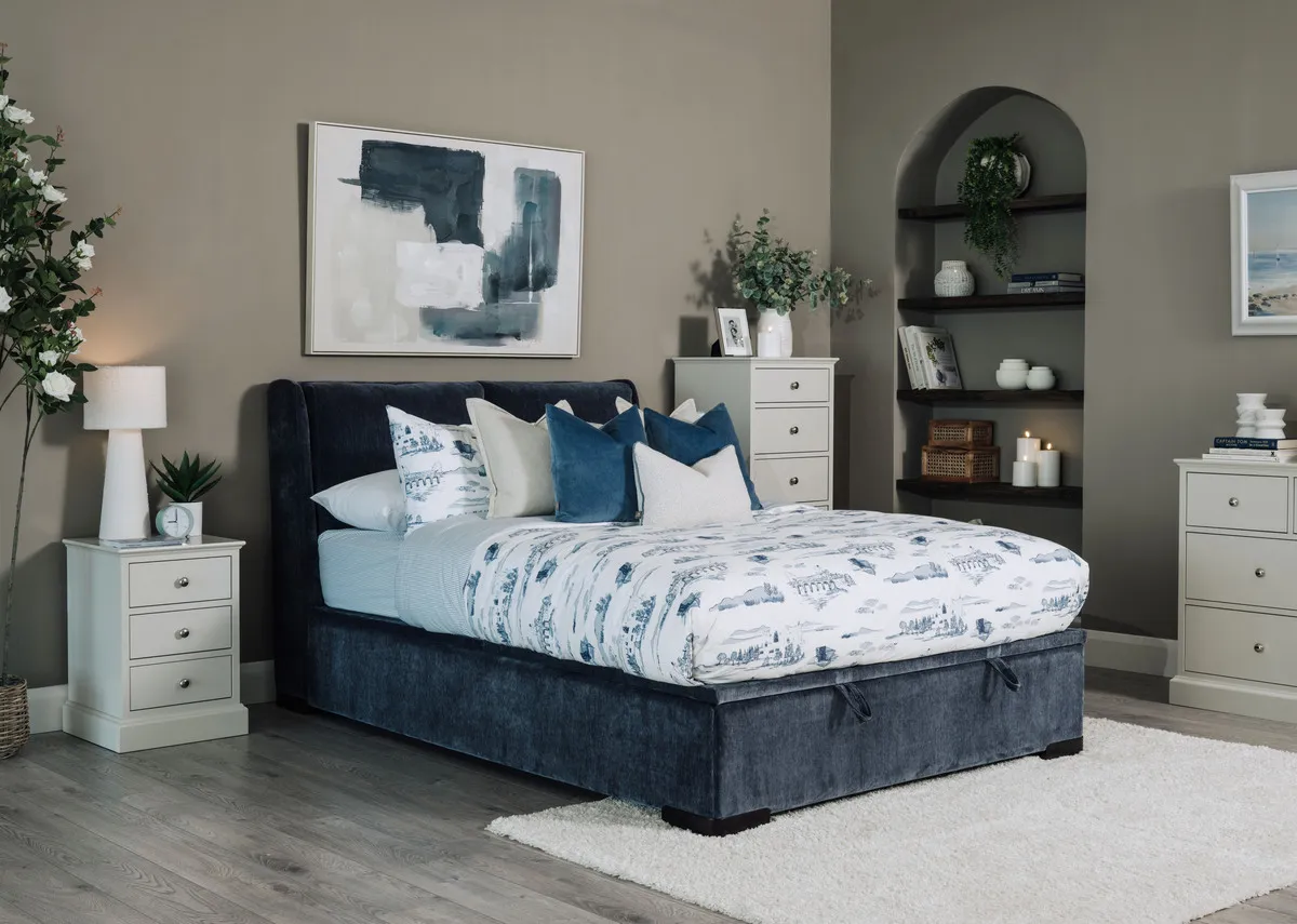 A lifestyle image of the Comfy blue ottoman bed fixed with rivendale locker and chests.