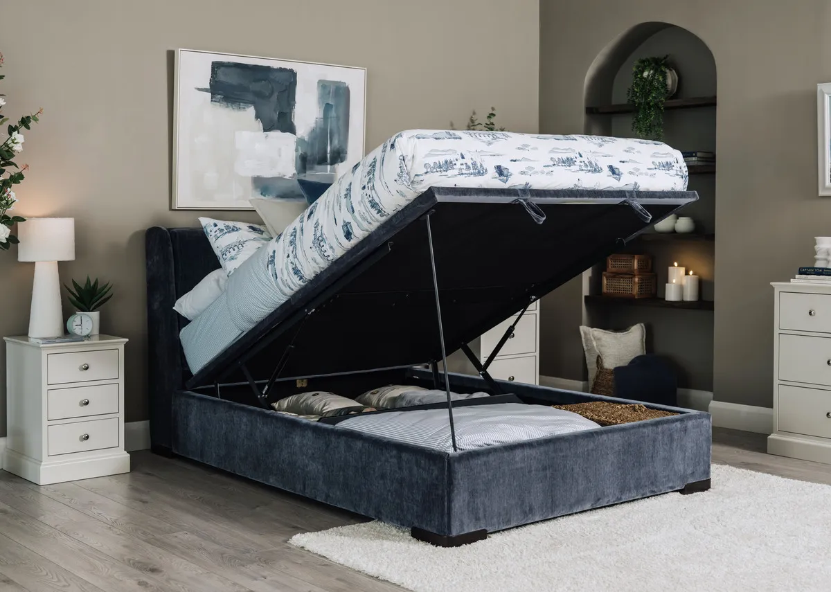 A lifestyle image of the Comfy blue ottoman bed open with Foxford toile duvet set and Riverdale locker and chests.