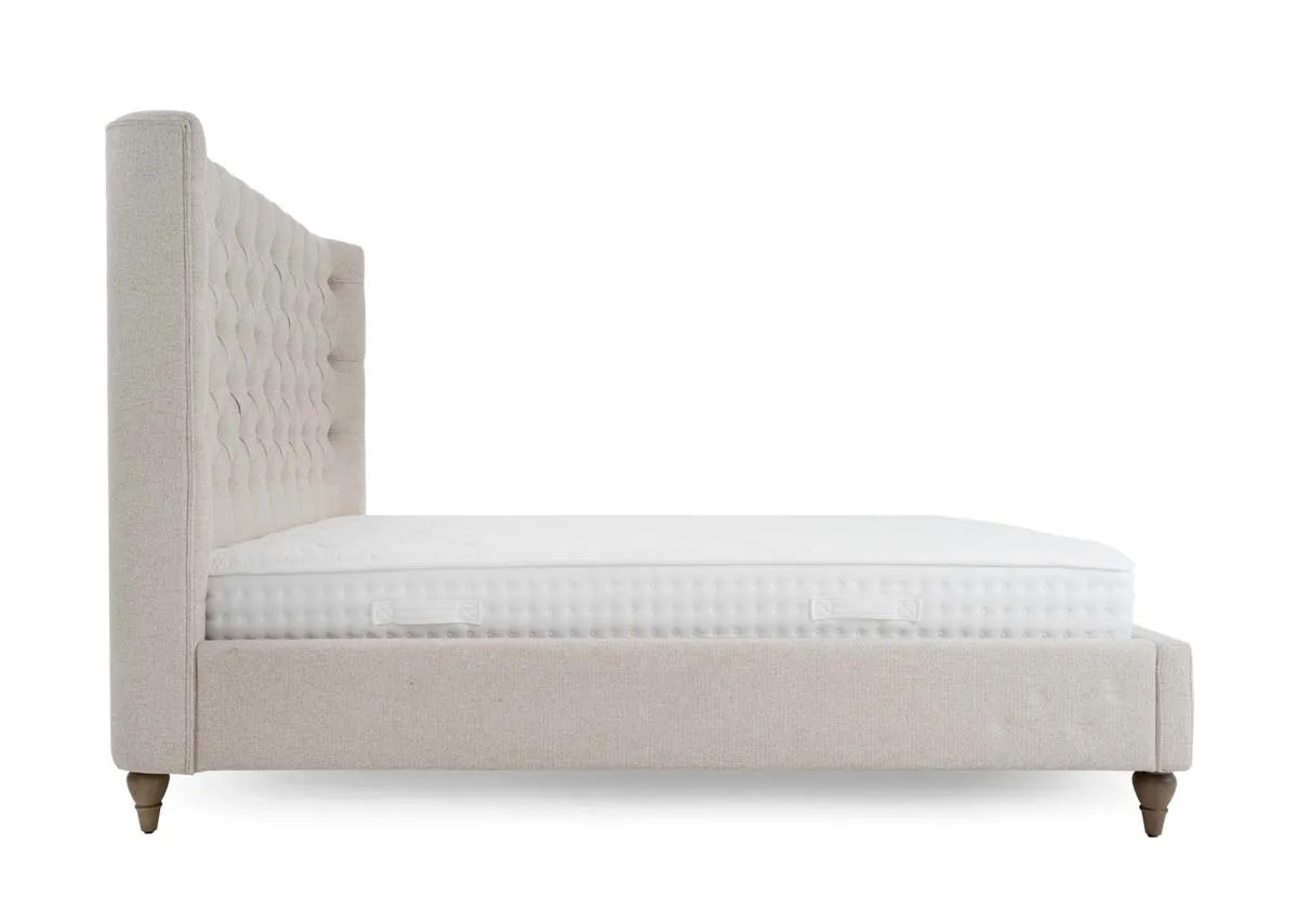 A cream fabric bed frame from EZ Livings Chelsea range. Side view of upholstered sides