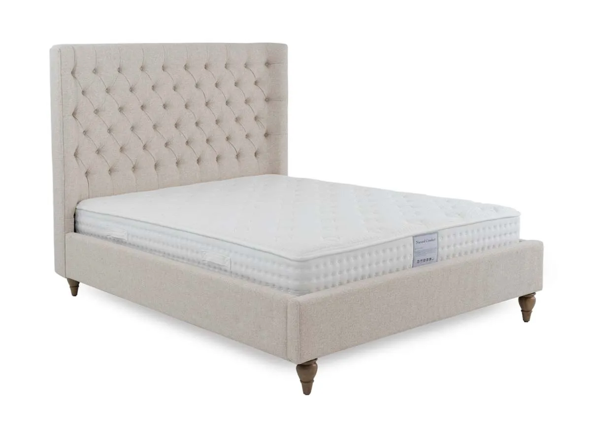 A cream fabric bed frame from EZ Livings Chelsea range. Angled view of bed with mattress not included.