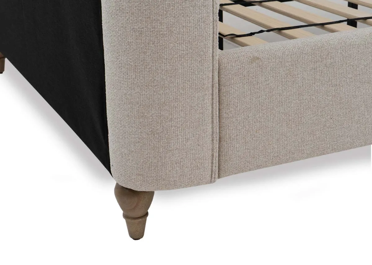 A cream fabric bed frame from EZ Livings Chelsea range. Closeup of ash wood legs