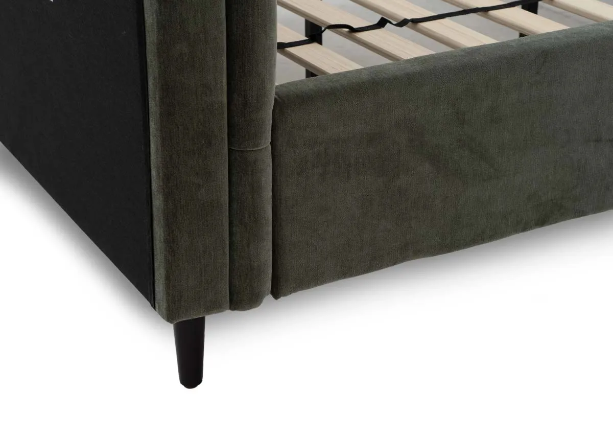 A green fabric bedframe with tufted Chesterfield detail with a closeup on the dark tapered leg