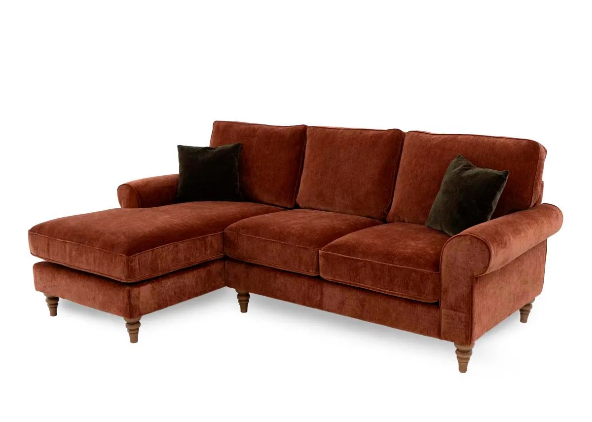 A rust fabric corner sofa from EZ Livings Cotswold range. Angled view of sofa with 2 green cushions.