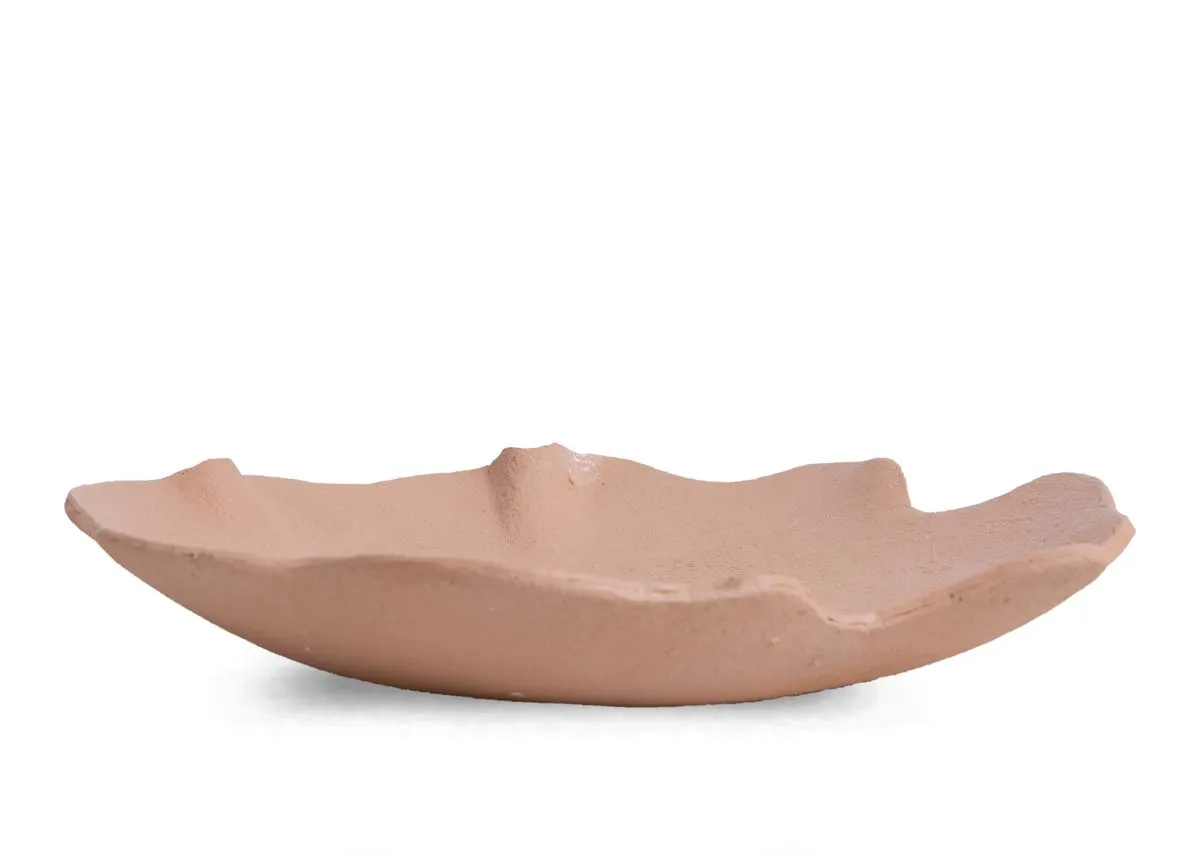 A peach decor bowl from EZ Livings Peony range. Side view of uneven edges.