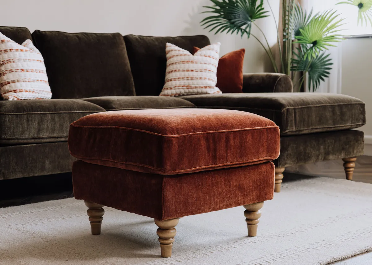 A lifestyle image of the Cotswold footstool with the Green chaise