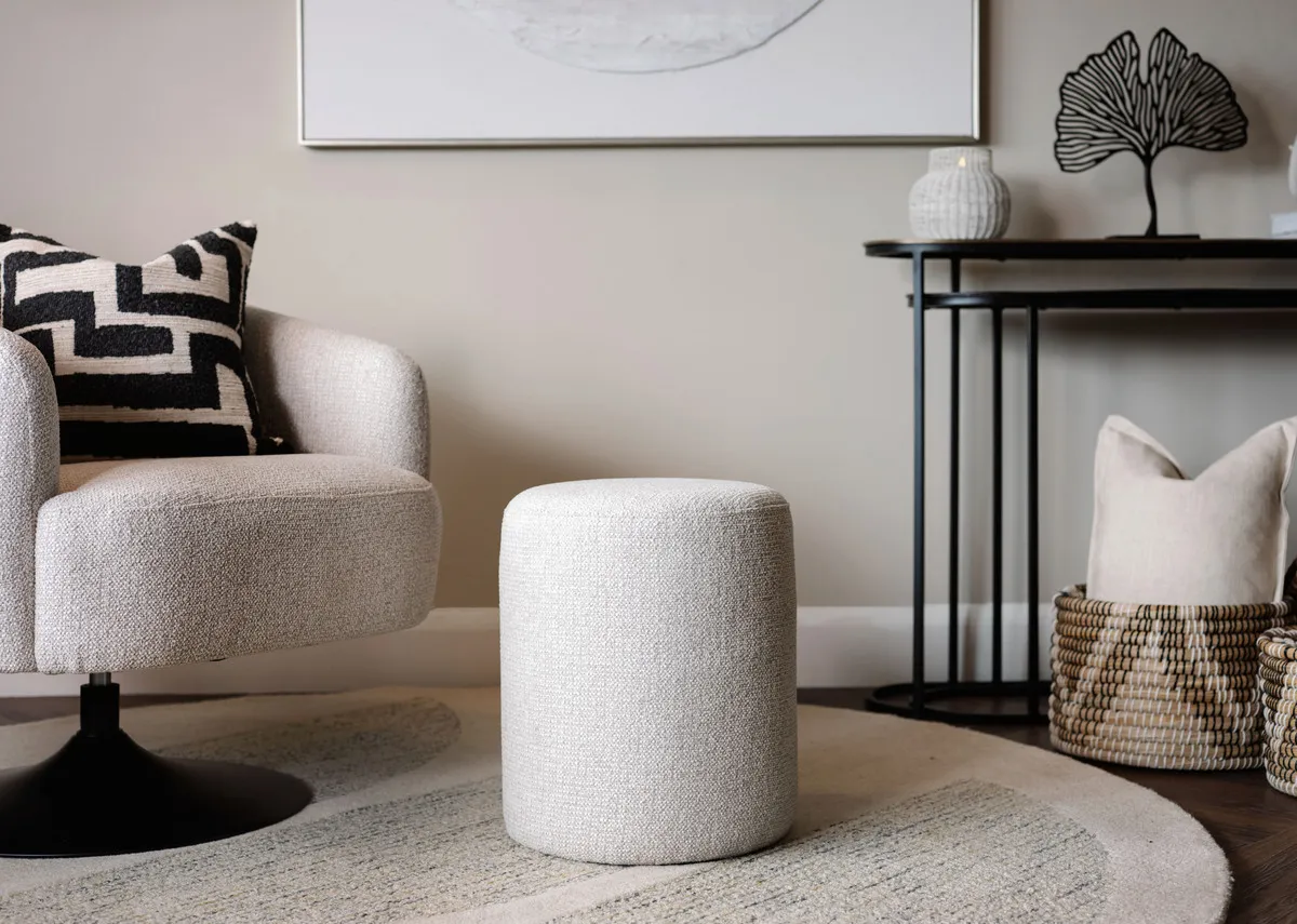 A lifestyle image of the Parker light grey footstool with Fusion swivel chair.
