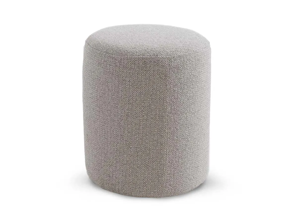 A cylindrical light grey fabric footstool from EZ Livings Parker range. Angled view.