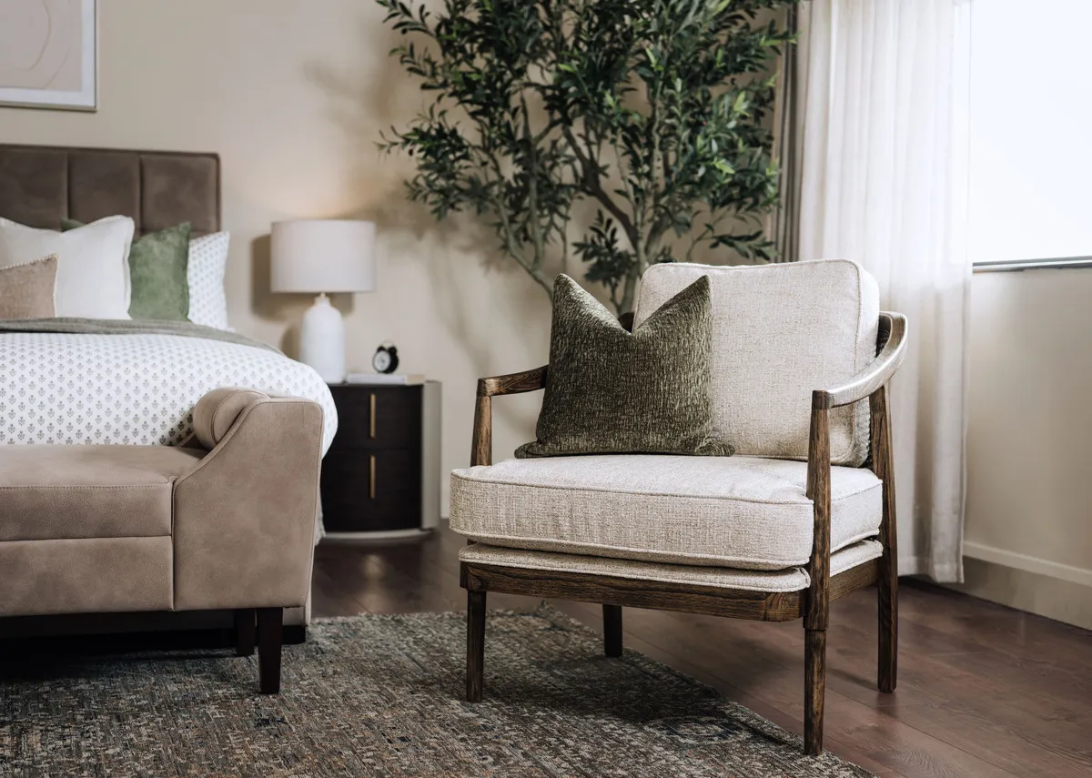 A lifestyle image of the Roundstone Chair with Rustic field cushion in a bedroom setting.