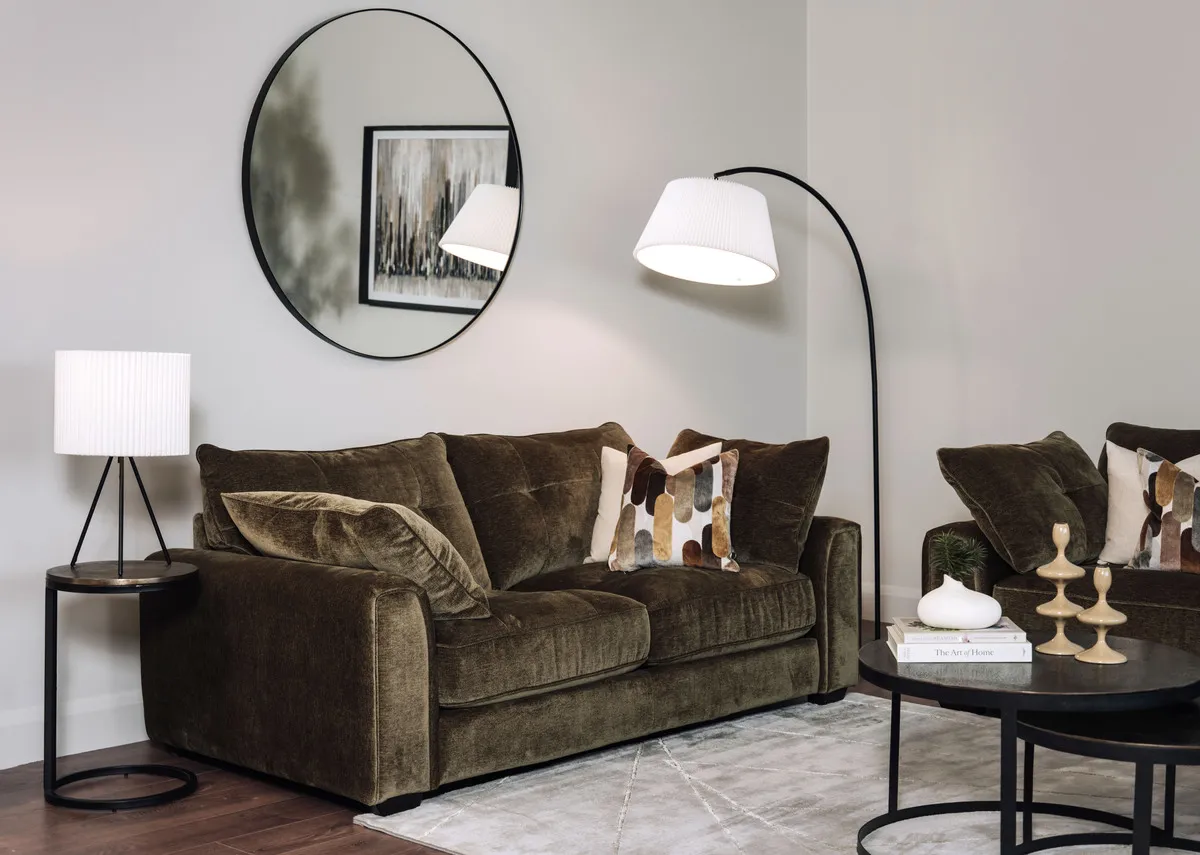 A lifestyle image of the Darcy 2 seater sofa with elling mirror with Toko tables