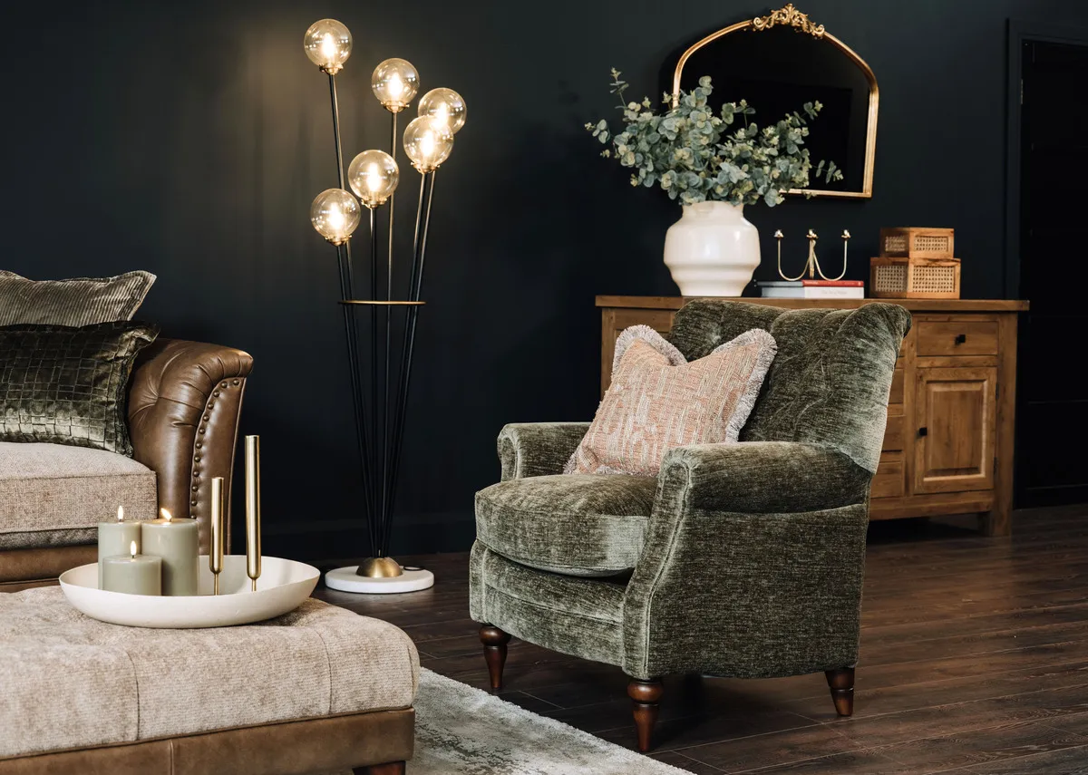 A lifestyle image of the Hudson green chair with the Savannah sofa and Ortez lamp.