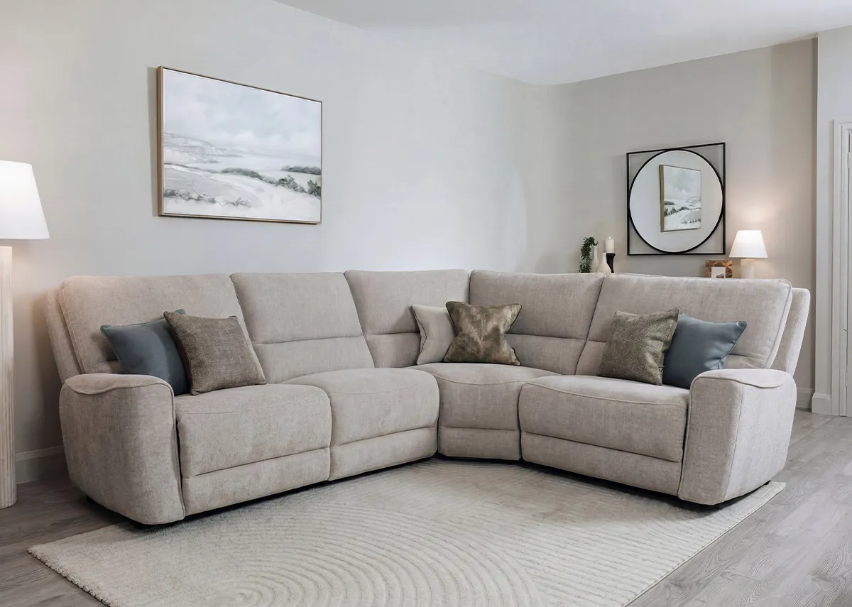 A beige fabric medium modular corner sofa from EZ Livings Ashbrook range. Angled view with 2 end seats fully reclined.