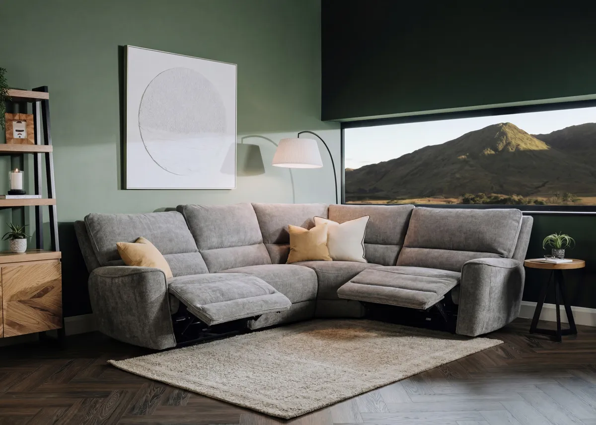 A lifestyle image of the Ashbrook medium grey corner sofa with 2 ends reclined.