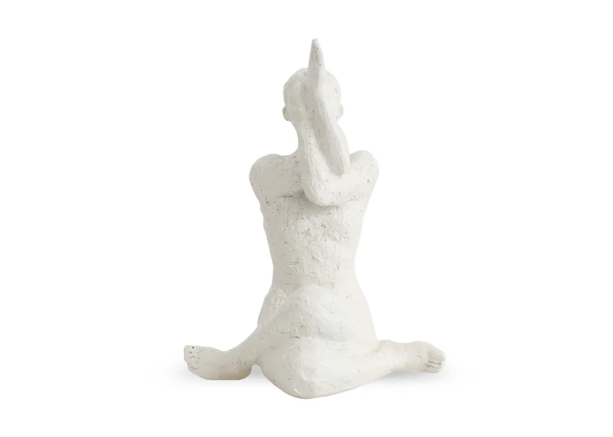 A white ornament shows a femalein a yoga pose.Front view